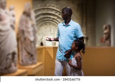 African American Man And His Daughter Visiting Exposition Of Museum With Exhibits Of Medieval Art