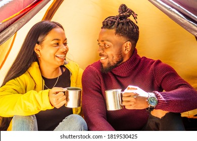 African American Man And Hispanic Woman Drinking Tea , Cooking Food On A Gas-burner