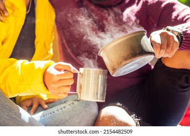 African American Man And Hispanic Woman Drinking Tea , Cooking Food On A Gas-burner