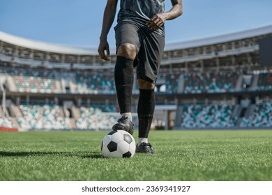 african american man holding a soccer ball in the stadium - Powered by Shutterstock