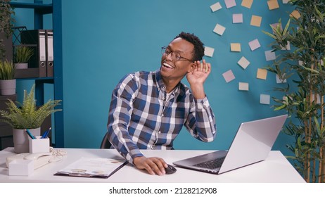 African American Man Listening To Gossip And Rumor At Laptop Computer, Finding Out Confidential Information And Eavesdropping. Young Person Overhearing Private Secret Conversation.