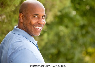 African American man looking back at the camera and smiling.