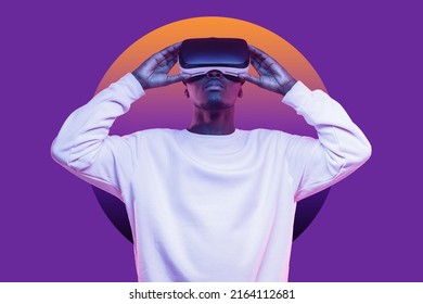 African American Man Looking Up In Vr Glasses, Playing Video Games, Experiencing Interactive Metaverse, Dressed In White Mockup Sweatshirt With Blank Copy Space, Isolated On Violet Wall With Circle