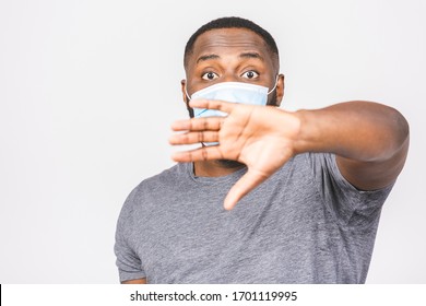 African American Man With Mask To Protect Him From Coronavirus. Corona Virus Pandemic. Stop Sign. Person In Medical Mask. Isolated Over White Background. Covid-19.