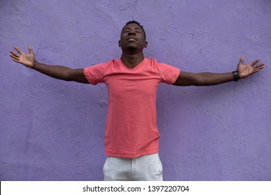 African American Man Model Posing In Empty Living Coral T-shirt At Violet Wall