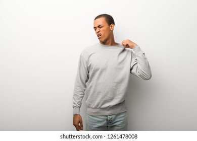African american man on white wall background with tired and sick expression