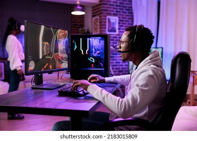 African American Man Playing Action Video Games On Stream Online, Using Computer To Play Rpg Tournament. Male Gamer Attending Esport Game Championship To Broadcast Live Gaming Content.