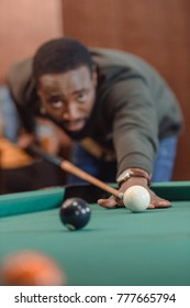 African American Man Playing In Pool At Bar