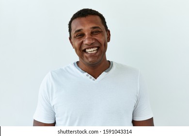 African American man portrait against white background. Laughter and joy emotions