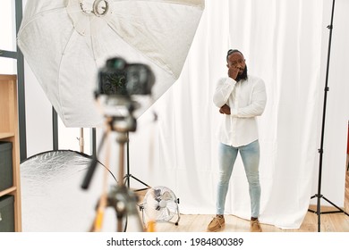 African American Man Posing As Model At Photography Studio Looking Stressed And Nervous With Hands On Mouth Biting Nails. Anxiety Problem. 