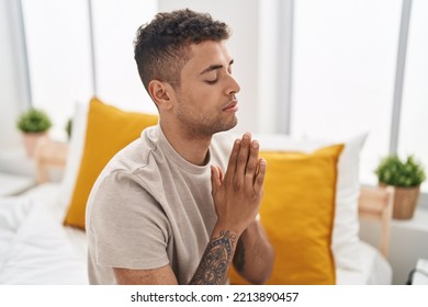 African American Man Praying Sitting On Bed At Bedroom