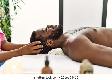 African american man reciving head massage at the clinic.
