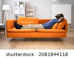 African American Man Relaxing On Sofa Or Couch