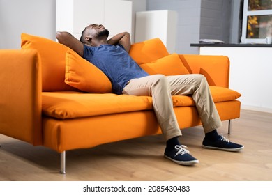 African American Man Relaxing On Sofa Or Couch - Powered by Shutterstock