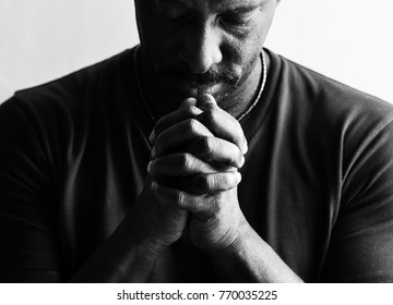 African American man resting his chin on his hands 