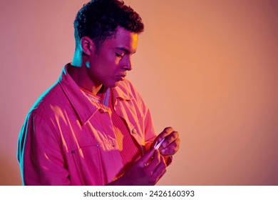 african american man rolling cigarette for smoking on vibrant background with blue neon lighting - Powered by Shutterstock