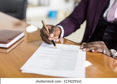 African American Man Signing Contract, Black Man Hand Putting Signature On Official Document, Biracial Clients Customers Couple Make Purchase Or Sign Prenuptial Agreement Concept. Clouse Up