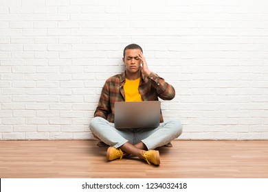 African american man sitting on the floor with his laptop unhappy and frustrated with something - Shutterstock ID 1234032418
