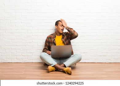 African american man sitting on the floor with his laptop has just realized something and has intending the solution - Shutterstock ID 1240294225