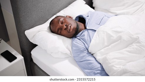 African American Man With Sleep Apnea Snoring - Powered by Shutterstock