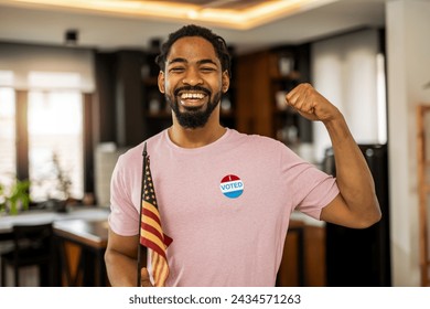 African American man standing with an American flag after voting. - Powered by Shutterstock