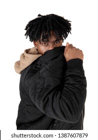 An African American Man Standing In The Studio Hiding His Face Behind
His Jacket Looking At The Camera, Isolated For White Background
