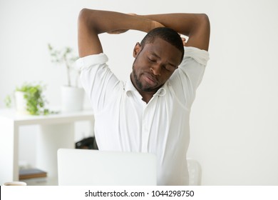 African American Man Stretching Doing Easy Office Exercises To Relieve Muscle Tension From Sedentary Work, Young Black Employee Taking Break For Relaxation At Workplace, Computer Syndrome Prevention