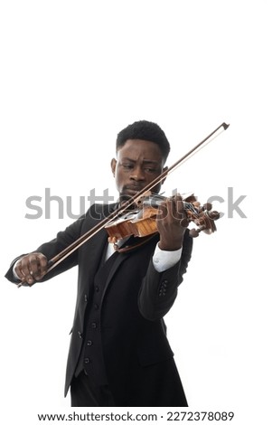 African american man in suit plays the violin in studio against white background