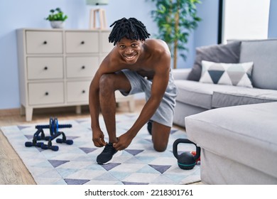 African American Man Tying Shoe At Home