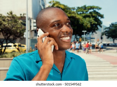 African American Man Using Cellphone In The City In A Warm Cinema Look