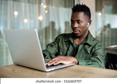 african american man using computer in cafe. young businessman working on his laptop