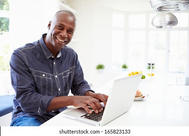 African American Man Using Laptop At Home