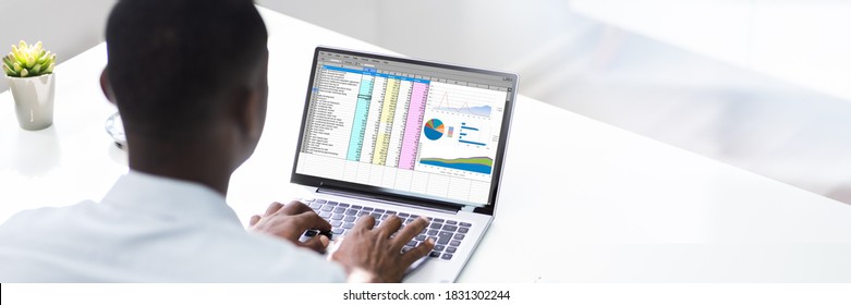 African American Man Using Spreadsheet Reports On Laptop Computer - Shutterstock ID 1831302244