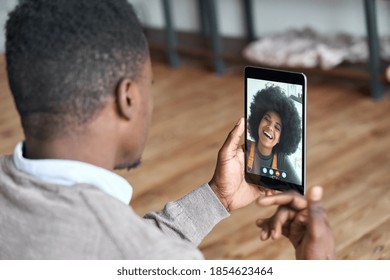 African American Man Video Calling Girlfriend On Digital Tablet. Black Couple Talking Dating By Virtual Meeting Via Conference Videocall. Remote Relationship, Online Chat Concept, Over Shoulder View.