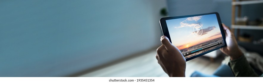 African American Man Watching TV Movie On Tablet