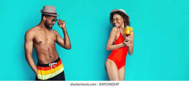 African American man wearing sunglasses and a hat is adjusting his sunglasses while looking to his right. A woman in a red swimsuit and a hat holds a cocktail with a smile on her face - Powered by Shutterstock