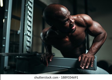 African American Man In White Pants Is Sitting In The Gym And Getting Ready For A Workout.