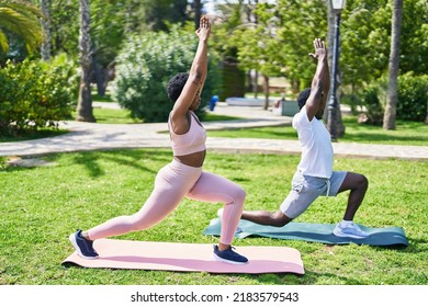 African american man and woman couple doing yoga exercise at park - Powered by Shutterstock