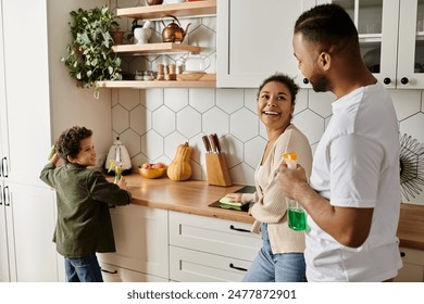 African American man and woman enjoying quality time in kitchen with son. - Powered by Shutterstock