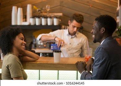 African american man and woman flirting talking at bar counter, black couple enjoying drinks and pleasant conversation on first date in cafe, young guy with lady having fun at meeting in coffee house