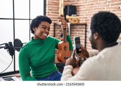 African American Man And Woman Music Group Make Photo Holding Ukelele At Music Studio