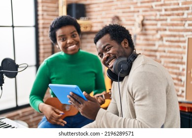 African American Man And Woman Music Group Using Touchpad Playing Ukelele At Music Studio