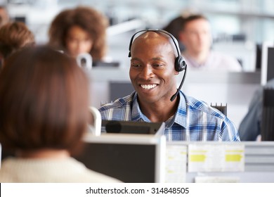 African American man working at a computer in a call centre - Shutterstock ID 314848505