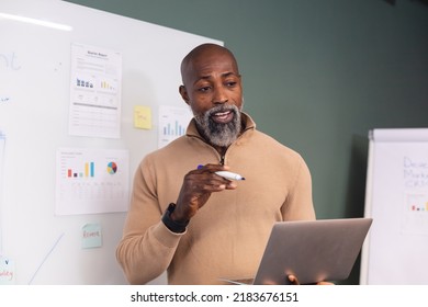 African American Mature Businessman Explaining Strategy Over Digital Tablet. Unaltered, Creative Business, Planning, Meeting, Presentation, Strategy, Technology.