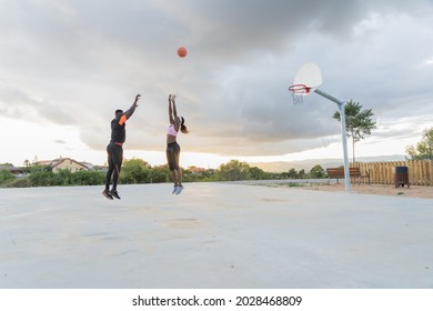 African American Middle Age Couple Playing One On One Basketball, Man Makes A Basket