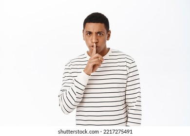 African American Middle Aged Man Shush, Showing Shhh, Taboo Sign Gesture, Press Finger To Lips With Serious Face Expression, White Background