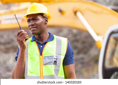 African American Mine Worker With Walkie-talkie At Mining Site