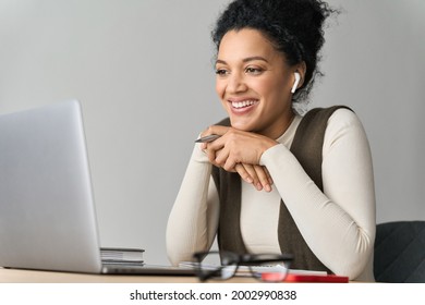 African American mixed race adult female student wearing earphones talking having virtual meeting online call, educational webinar at home office. Video learning conference call on pc.