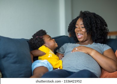 African American mom and her daughter talking.