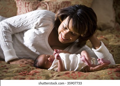 African American Mother Admiring Her Newborn Child